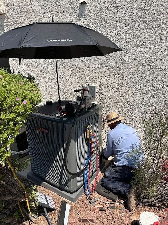 HVAC technician performing outdoor AC maintenance in Carbondale